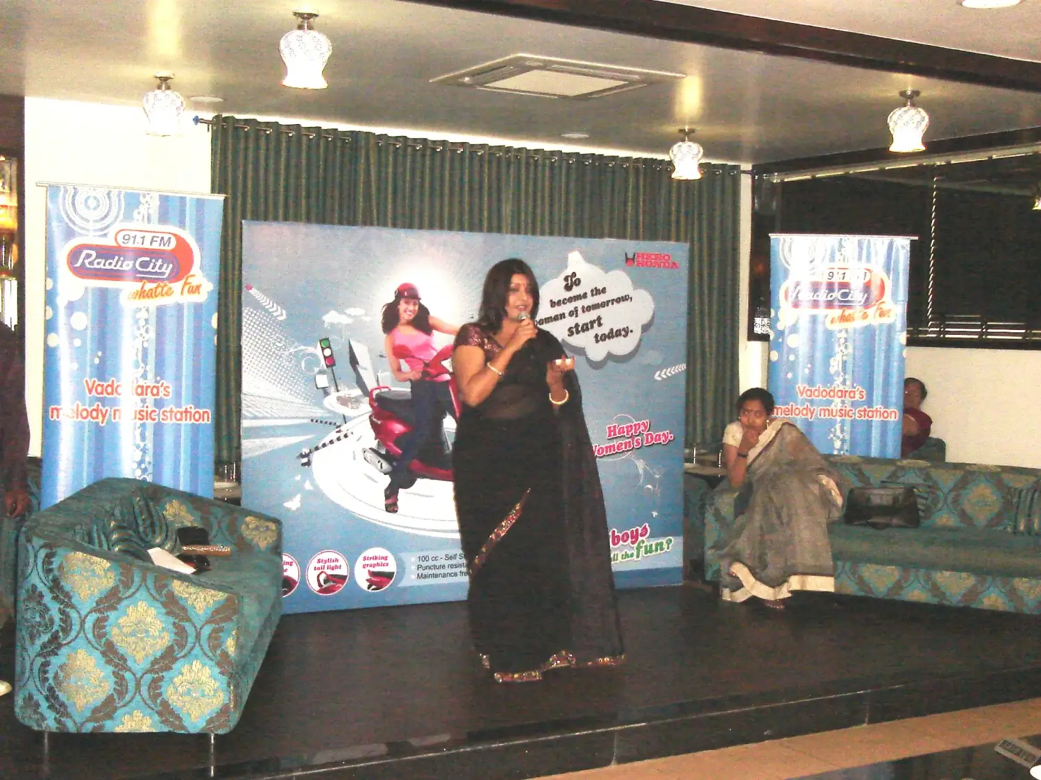 ITT event entrance with red and green carpet and pink lighting on white structure with ITT branding